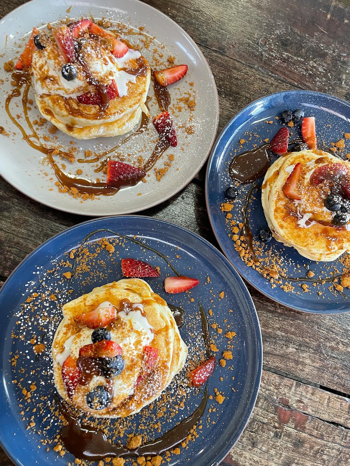 Pancake stacks with berries, caramel and crumble